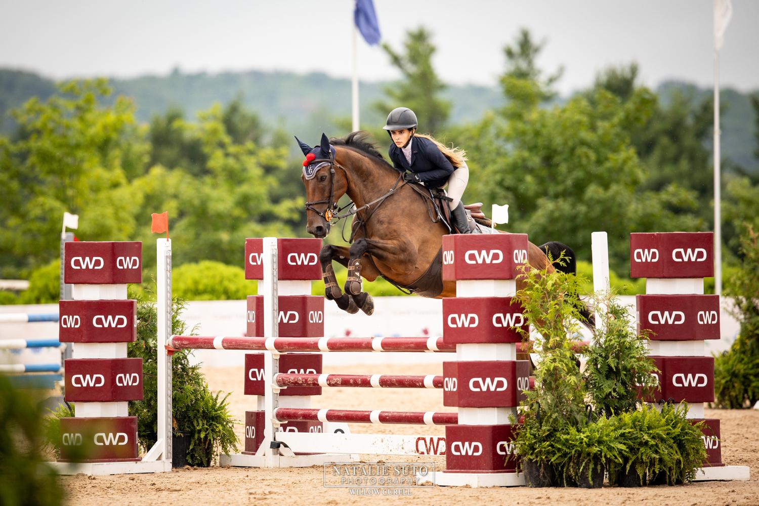 Emma Pombo jumping a CWD obstacle at Traverse City Horse Shows