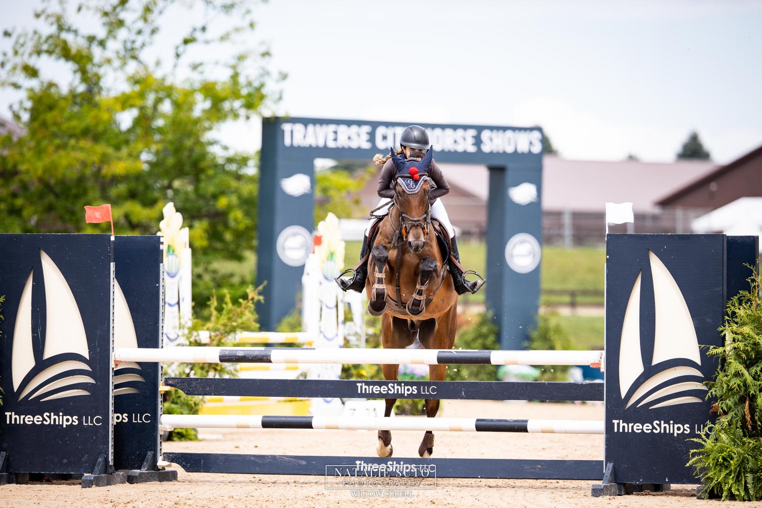 Emma Pombo jumping the Three Ships obstacle at Traverse City Horse Shows